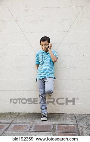Stock Photo - Mixed race boy talking on cell phone. Fotosearch