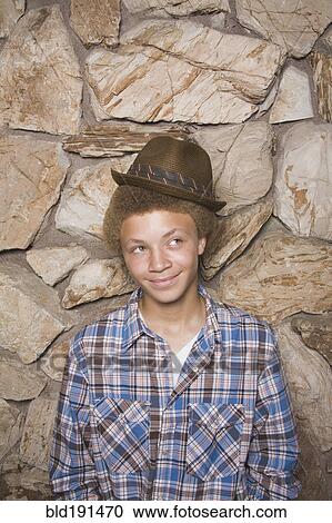 Stock Image - Mixed race boy wearing fedora. Fotosearch