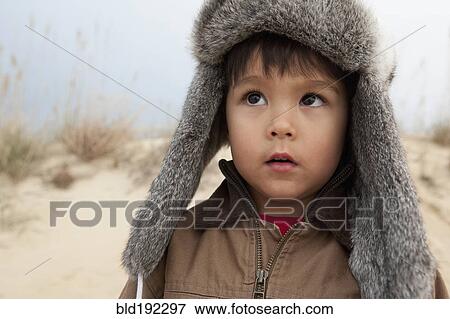 Mixed race boy wearing fur hat View Large Photo Image Stock Photo - Mixed race boy wearing fur hat. Fotosearch