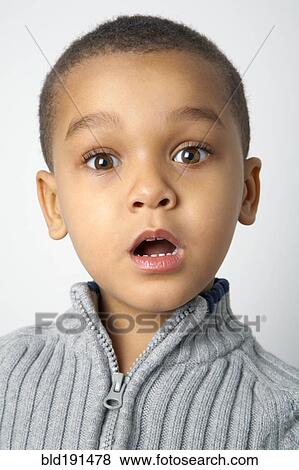 Stock Photo - Mixed race boy with surprised expression. Fotosearch