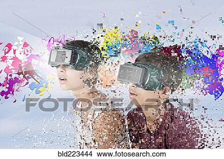 Picture - Mixed Race brother and sister watching paint splatter with VR goggles. Fotosearch