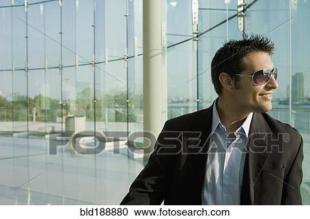 Mixed race businessman in glass walled room View Large Photo Image Stock Image - Mixed race businessman in glass walled room. Fotosearch