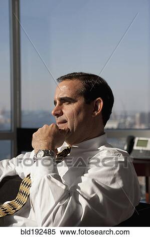 Stock Photography - Mixed race businessman looking pensive. Fotosearch