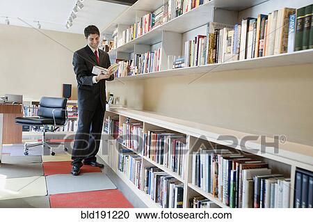 Mixed race businessman reading book View Large Photo Image Stock Image - Mixed race businessman reading book. Fotosearch