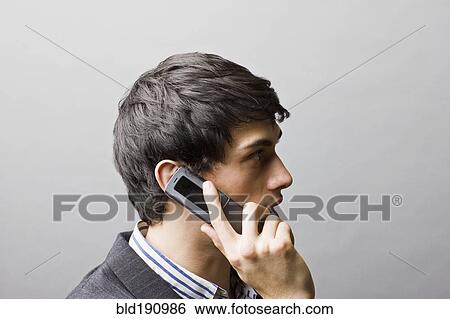 Mixed race businessman talking on cell phone View Large Photo Image Stock Photograph - Mixed race businessman talking on cell phone. Fotosearch