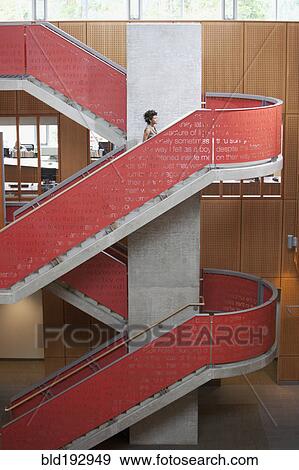 Mixed race businesswoman climbing stairs in office View Large Photo Image Stock Photo - Mixed race businesswoman climbing stairs in office. Fotosearch