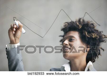 Mixed race businesswoman drawing on clear board View Large Photo Image Stock Image - Mixed race businesswoman drawing on clear board. Fotosearch