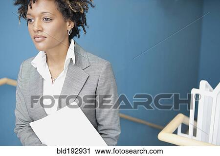 Mixed race businesswoman in stairwell View Large Photo Image Stock Image - Mixed race businesswoman in stairwell. Fotosearch