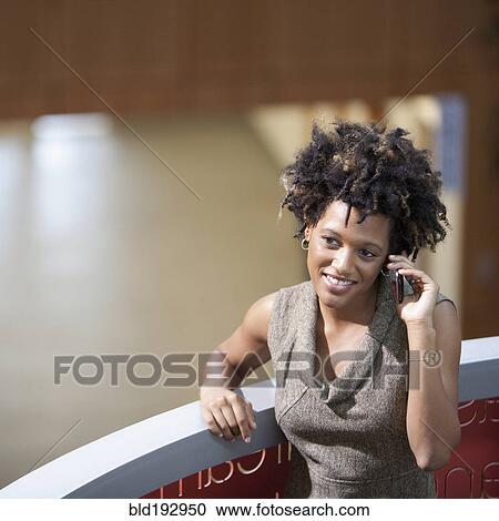 Mixed race businesswoman talking on cell phone View Large Photo Image Stock Image - Mixed race businesswoman talking on cell phone. Fotosearch