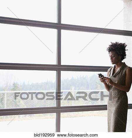 Mixed race businesswoman text messaging on cell phone View Large Photo Image Stock Photo - Mixed race businesswoman text messaging on cell phone. Fotosearch