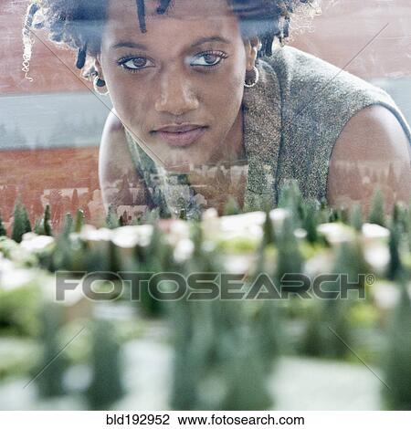 Stock Image - Mixed race businesswoman viewing development model. Fotosearch