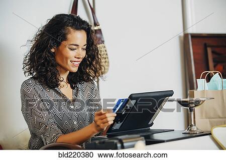 Mixed race clerk swiping credit card at register View Large Photo Image Stock Image - Mixed race clerk swiping credit card at register. Fotosearch