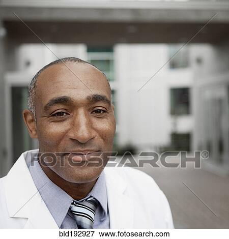 Mixed race doctor standing outdoors View Large Photo Image Stock Photo - Mixed race doctor standing outdoors. Fotosearch