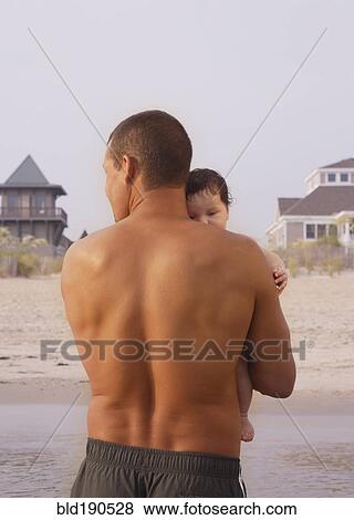 Stock Photo - Mixed Race father holding baby. Fotosearch