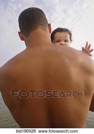 Stock Photograph - Mixed Race father holding baby. Fotosearch