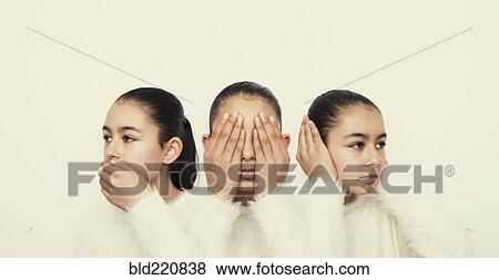 Stock Photo - Mixed race girl covering mouth, eyes and ears. Fotosearch