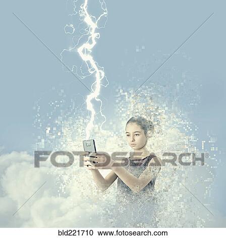Stock Image - Mixed race girl holding cell phone in lightning. Fotosearch