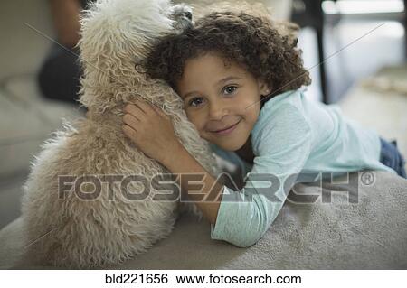 Mixed race girl hugging dog View Large Photo Image Stock Photograph - Mixed race girl hugging dog. Fotosearch