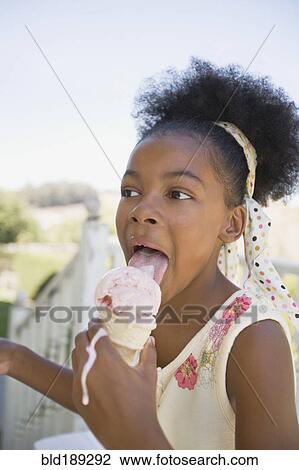 Mixed race girl licking melting ice cream cone View Large Photo Image Stock Image - Mixed race girl licking melting ice cream cone. Fotosearch