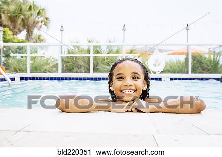 Mixed race girl smiling in swimming pool View Large Photo Image Stock Image - Mixed race girl smiling in swimming pool. Fotosearch