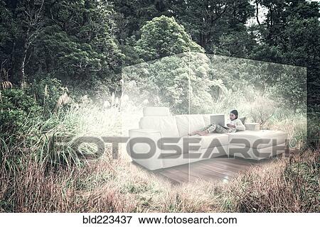 Stock Photo - Mixed Race girl using laptop on sofa in virtual cube. Fotosearch