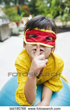 Mixed race girl wearing mask and gesturing View Large Photo Image Stock Photograph - Mixed race girl wearing mask and gesturing. Fotosearch