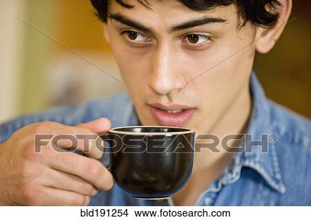 Picture - Mixed race man drinking coffee. Fotosearch