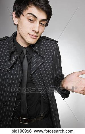 Stock Photograph - Mixed race man in fashionable coat. Fotosearch