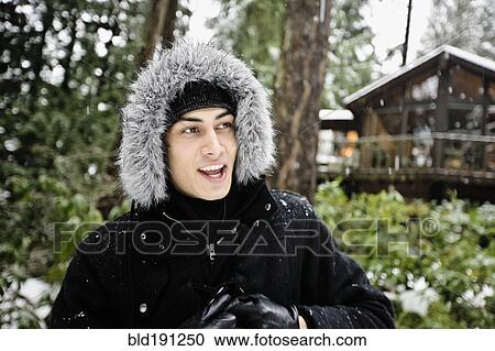 Mixed race man in hooded coat outdoors in snowfall View Large Photo Image Stock Image - Mixed race man in hooded coat outdoors in snowfall. Fotosearch