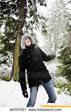 Mixed race man in hooded coat outdoors in snowfall View Large Photo Image Stock Image - Mixed race man in hooded coat outdoors in snowfall. Fotosearch
