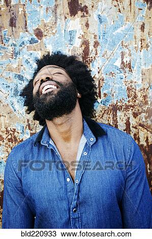 Stock Image - Mixed race man smiling outdoors. Fotosearch