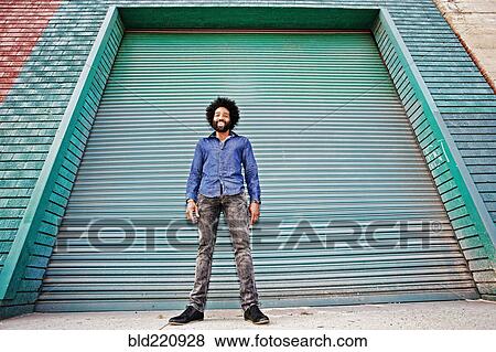 Stock Photo - Mixed race man smiling outdoors. Fotosearch