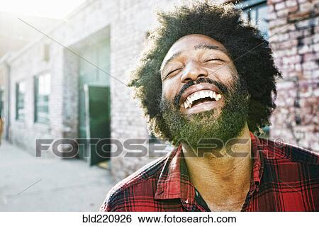 Stock Photograph - Mixed race man smiling outdoors. Fotosearch