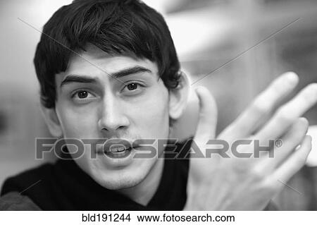 Picture - Mixed race man talking. Fotosearch