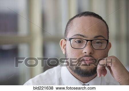 Mixed race man with down syndrome resting chin in hands View Large Photo Image Stock Photo - Mixed race man with down syndrome resting chin in hands. Fotosearch
