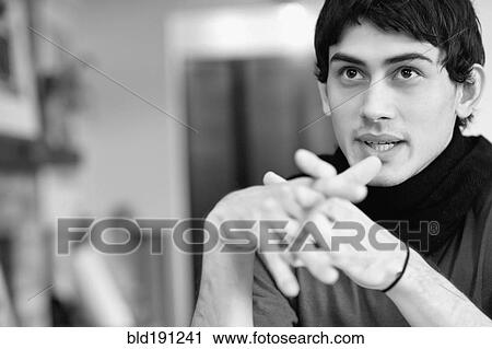 Mixed race man with hands clasped View Large Photo Image Stock Image - Mixed race man with hands clasped. Fotosearch
