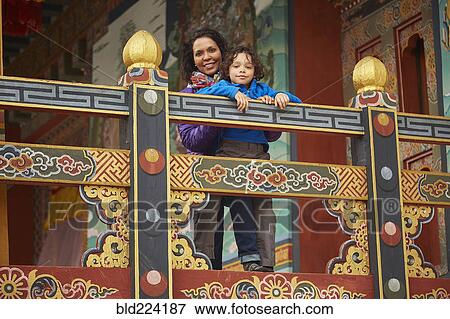 Mixed Race mother holding son on balcony View Large Photo Image Stock Photo - Mixed Race mother holding son on balcony. Fotosearch