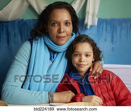 Mixed Race mother hugging son View Large Photo Image Stock Photo - Mixed Race mother hugging son. Fotosearch
