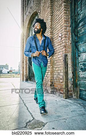 Mixed race musician carrying guitar outdoors View Large Photo Image Stock Photography - Mixed race musician carrying guitar outdoors. Fotosearch