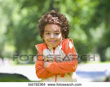 Picture - Mixed race outdoors with arms crossed. Fotosearch