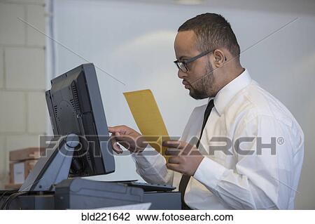 Stock Image - Mixed race server with down syndrome entering order in restaurant. Fotosearch