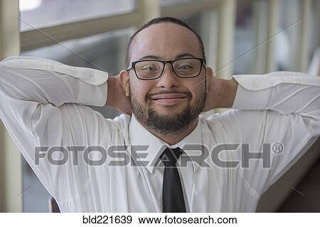 Stock Photo - Mixed race server with down syndrome smiling in restaurant. Fotosearch