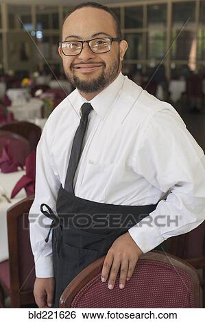 Mixed race server with down syndrome smiling in restaurant View Large Photo Image Stock Photograph - Mixed race server with down syndrome smiling in restaurant. Fotosearch