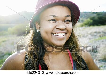 Mixed Race teenager smiling in field View Large Photo Image Stock Image - Mixed Race teenager smiling in field. Fotosearch