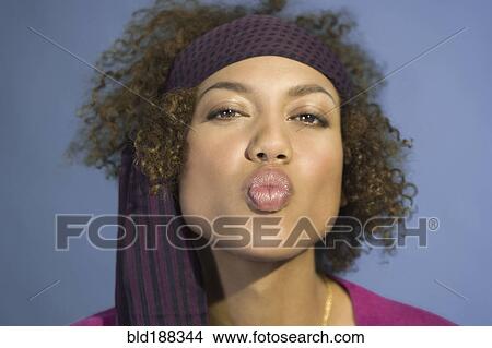 Picture - Mixed Race woman blowing kiss. Fotosearch