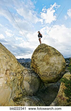 Mixed race woman climbing rock formation View Large Photo Image Stock Image - Mixed race woman climbing rock formation. Fotosearch