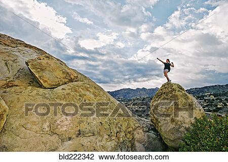 Mixed race woman climbing rock formation View Large Photo Image Stock Image - Mixed race woman climbing rock formation. Fotosearch