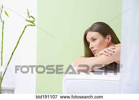 Stock Photo - Mixed race woman laying in spa resort. Fotosearch