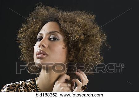 Mixed Race woman pulling hair View Large Photo Image Stock Image - Mixed Race woman pulling hair. Fotosearch
