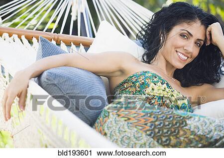 Mixed race woman relaxing in hammock View Large Photo Image Stock Image - Mixed race woman relaxing in hammock. Fotosearch